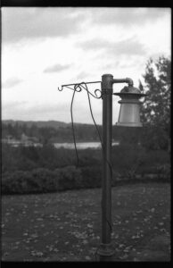 a black and white photo of a lamp post