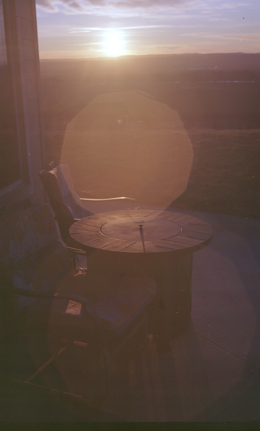 A lens flare on a photo of the sunset taken on a film camera