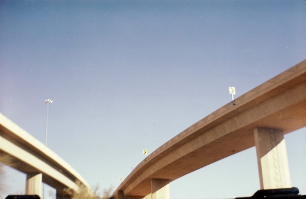A film photo on expired film of an overpass from the highway in Arizona heading into Phoenix.
