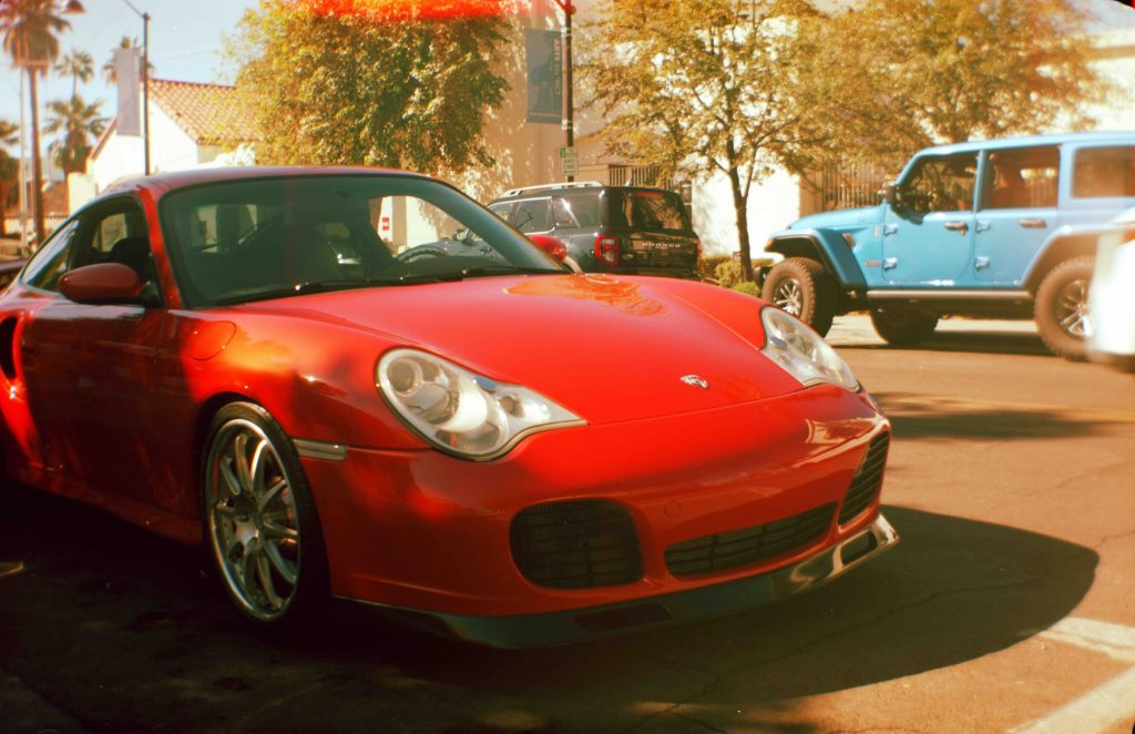 A film photo on expired color negative film of a red Porsche outside a Coffee shop in Scottsdale, AZ.